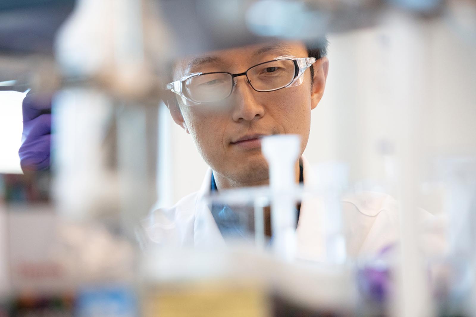 Scientist reviewing test tubes