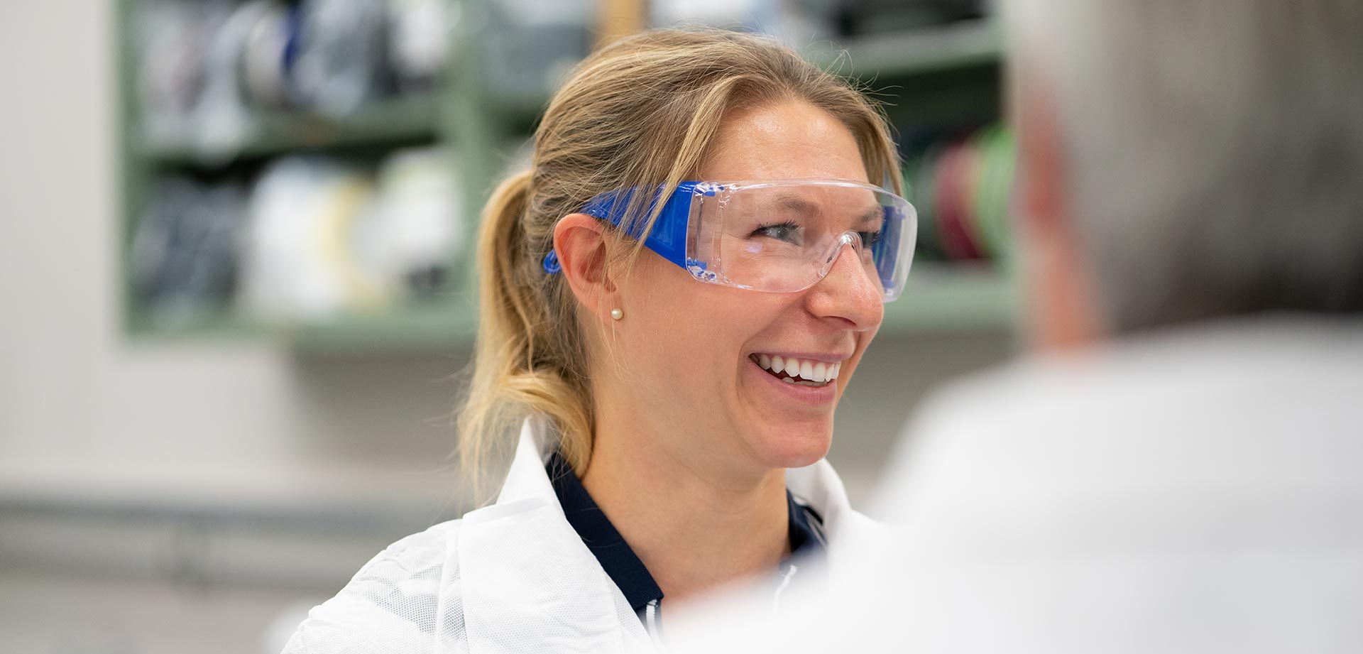 Scientist smiling wearing goggles