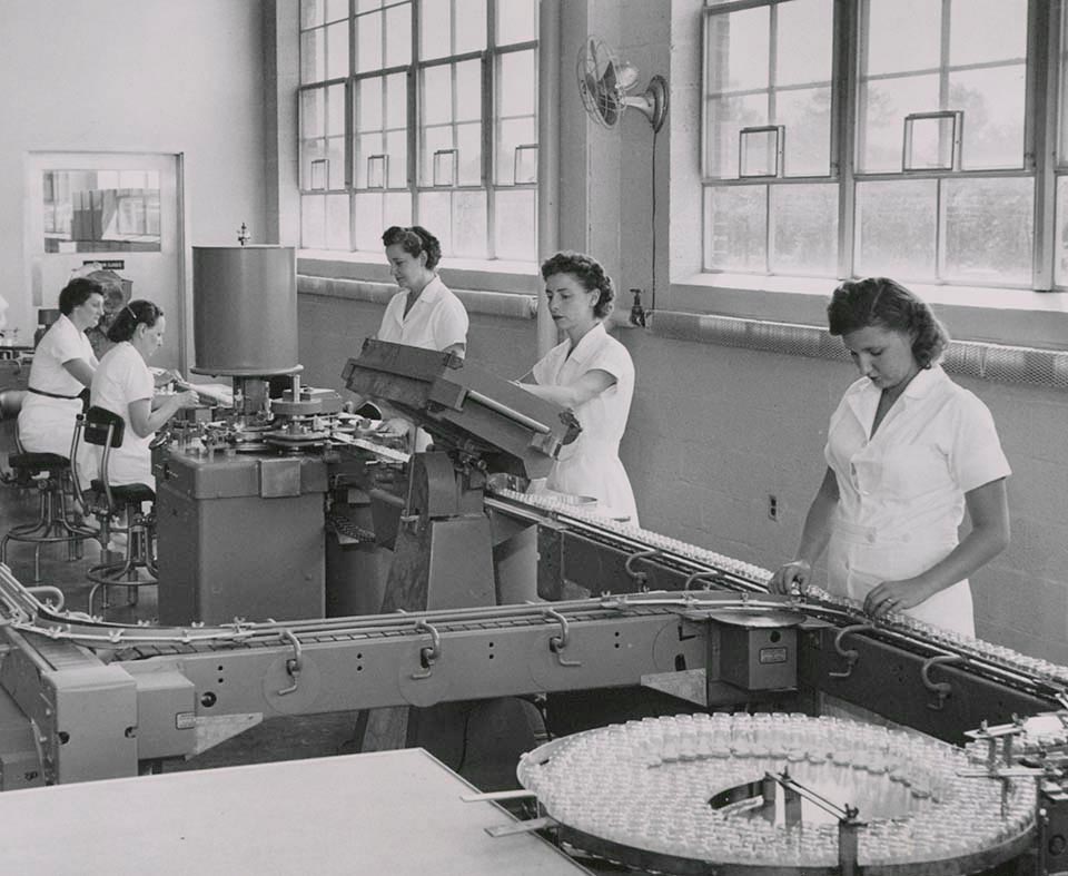 Female employees working with machinery