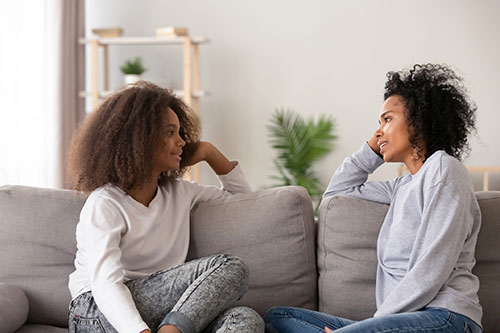 women talking on the couch