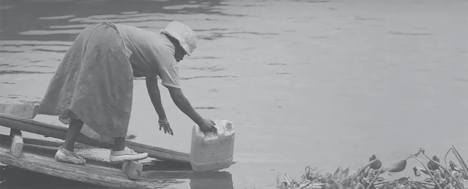 woman fetching water from the river