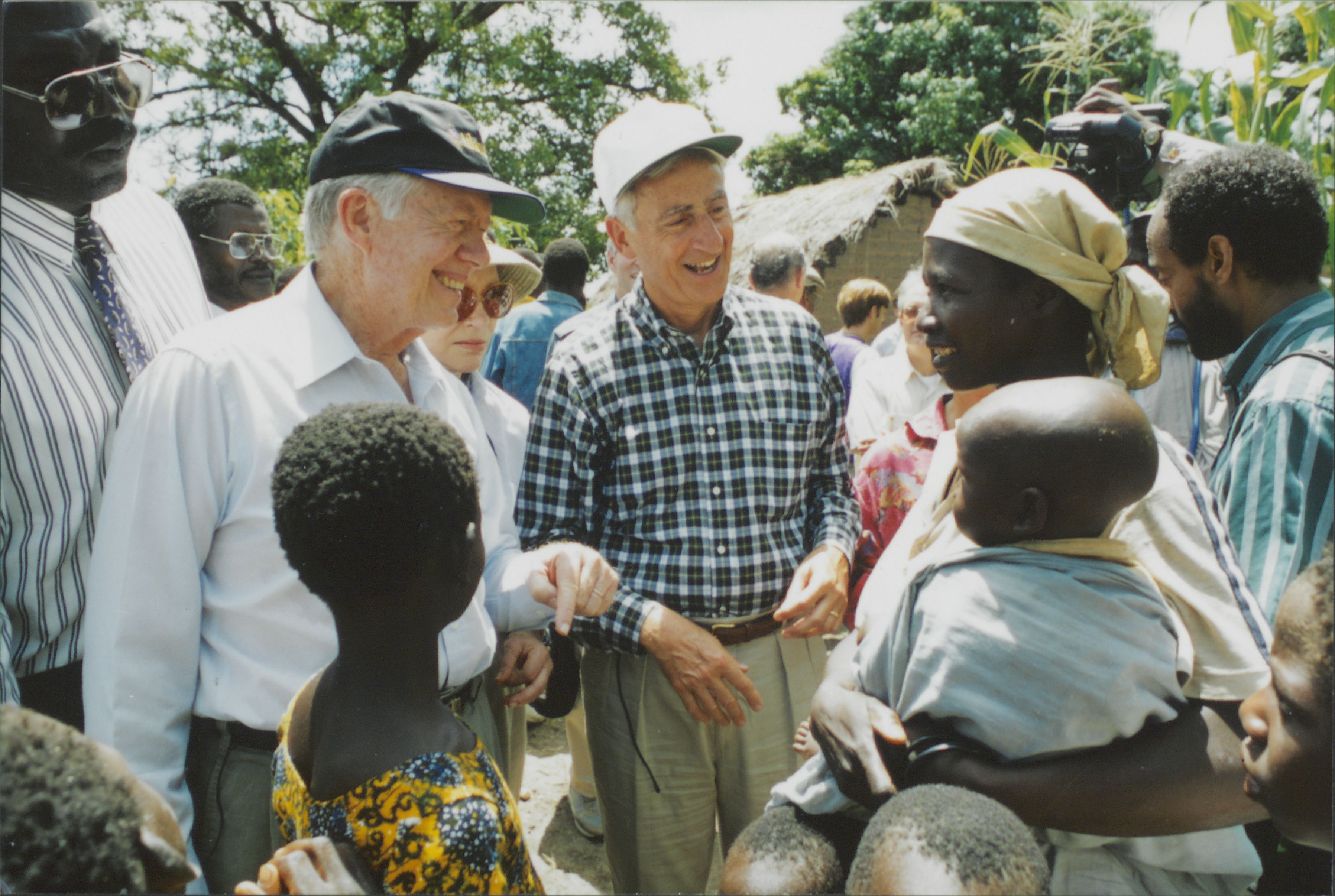 Former President Jimmy Carter and retired ww5 CEO Roy Vagelos meet with people affected by river blindness