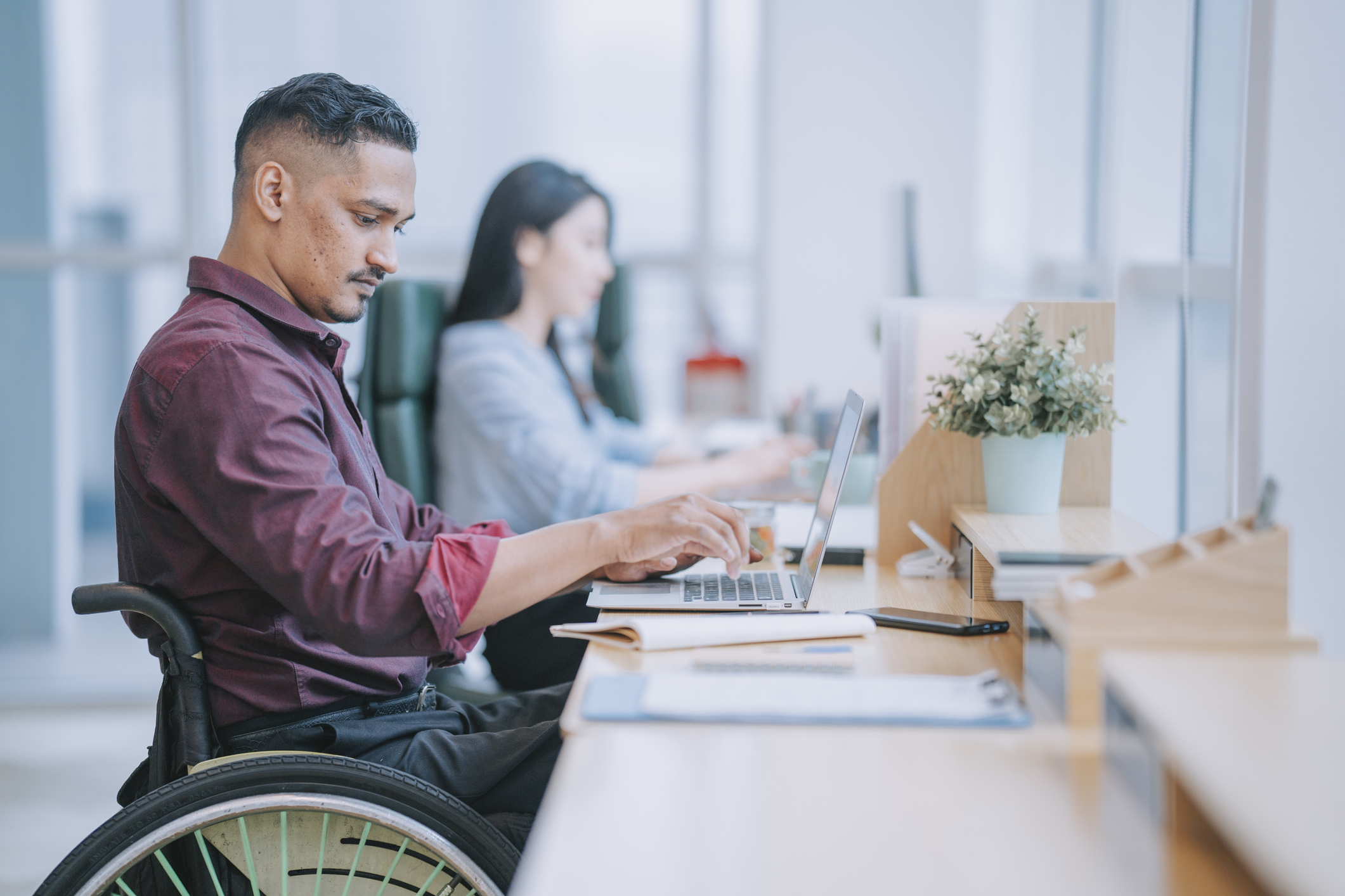 man in wheelchair working
