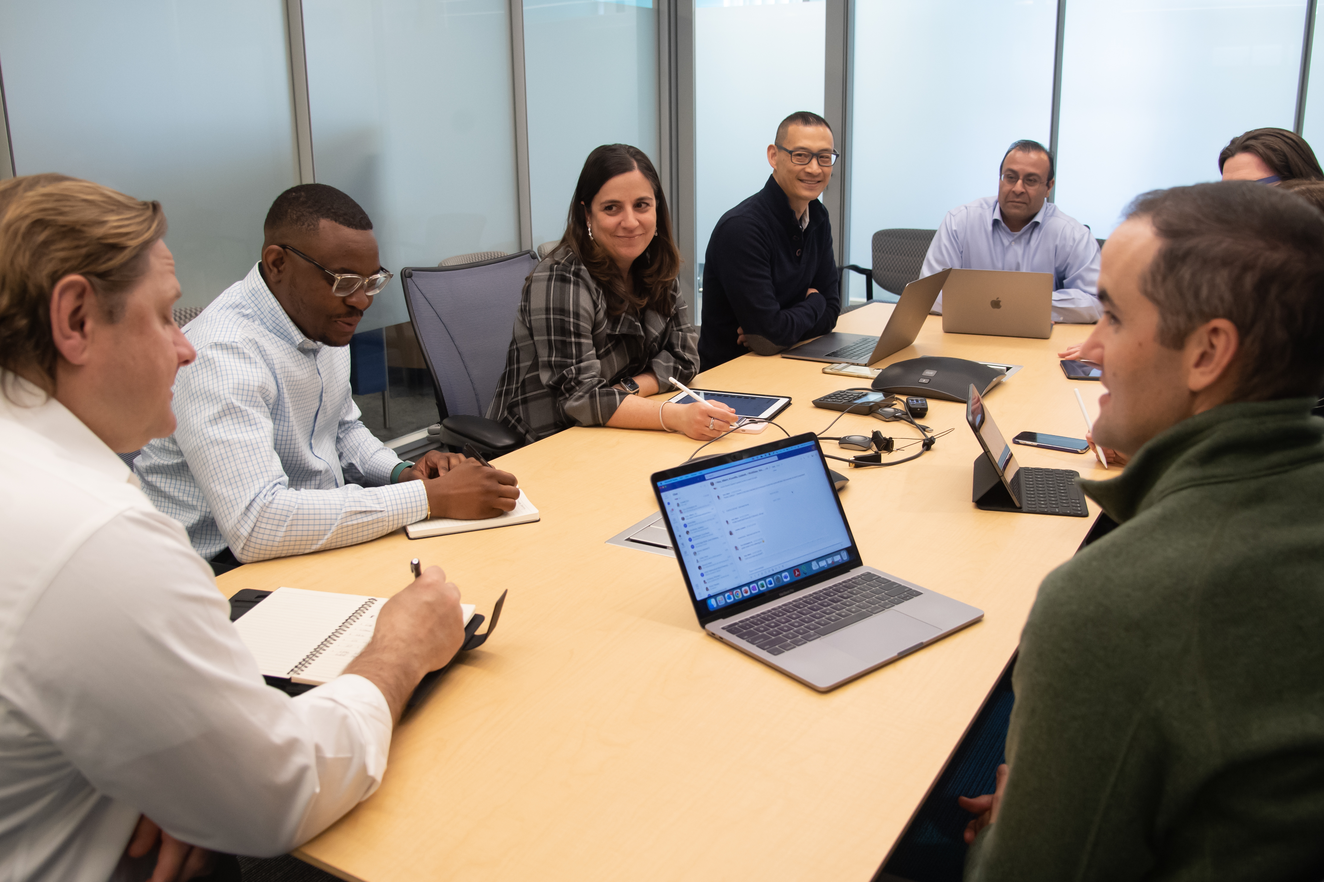 group of people in conference room table talking