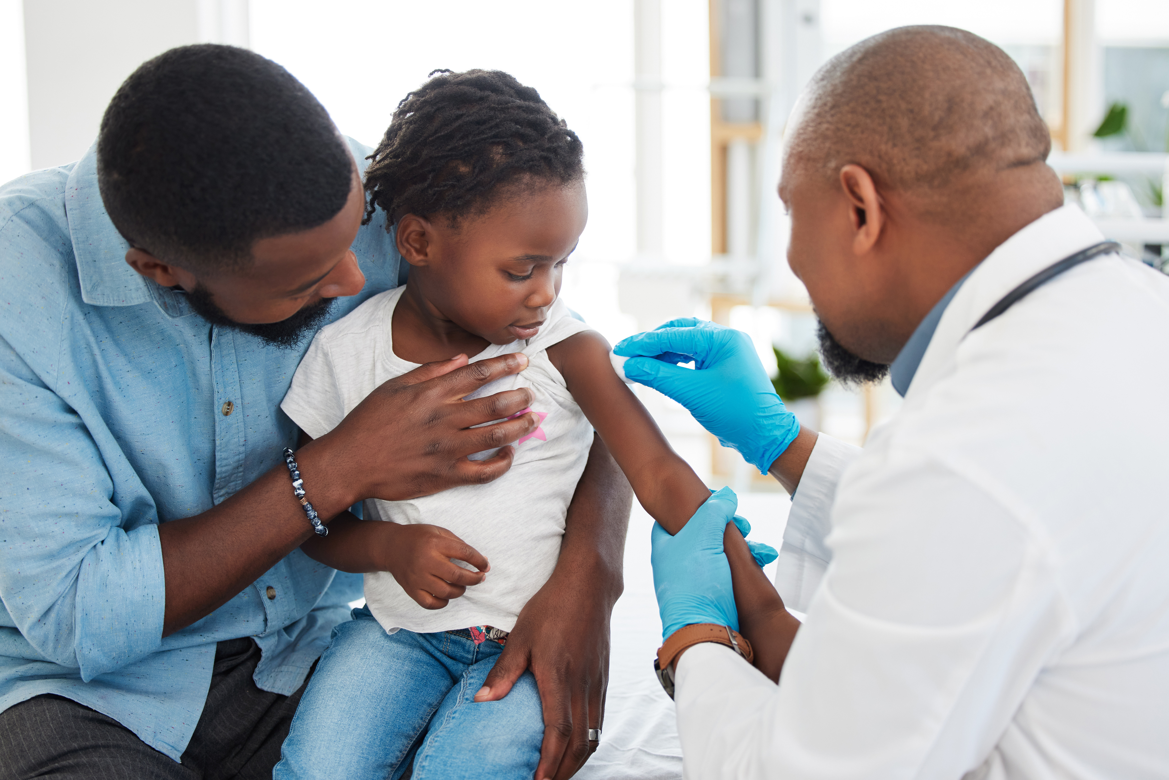 Boy child getting vaccine by doctor