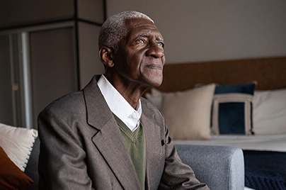 Senior man staring out of window
